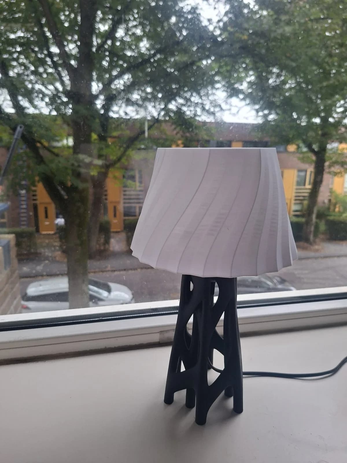 Black openwork base with a white spiral shade.
