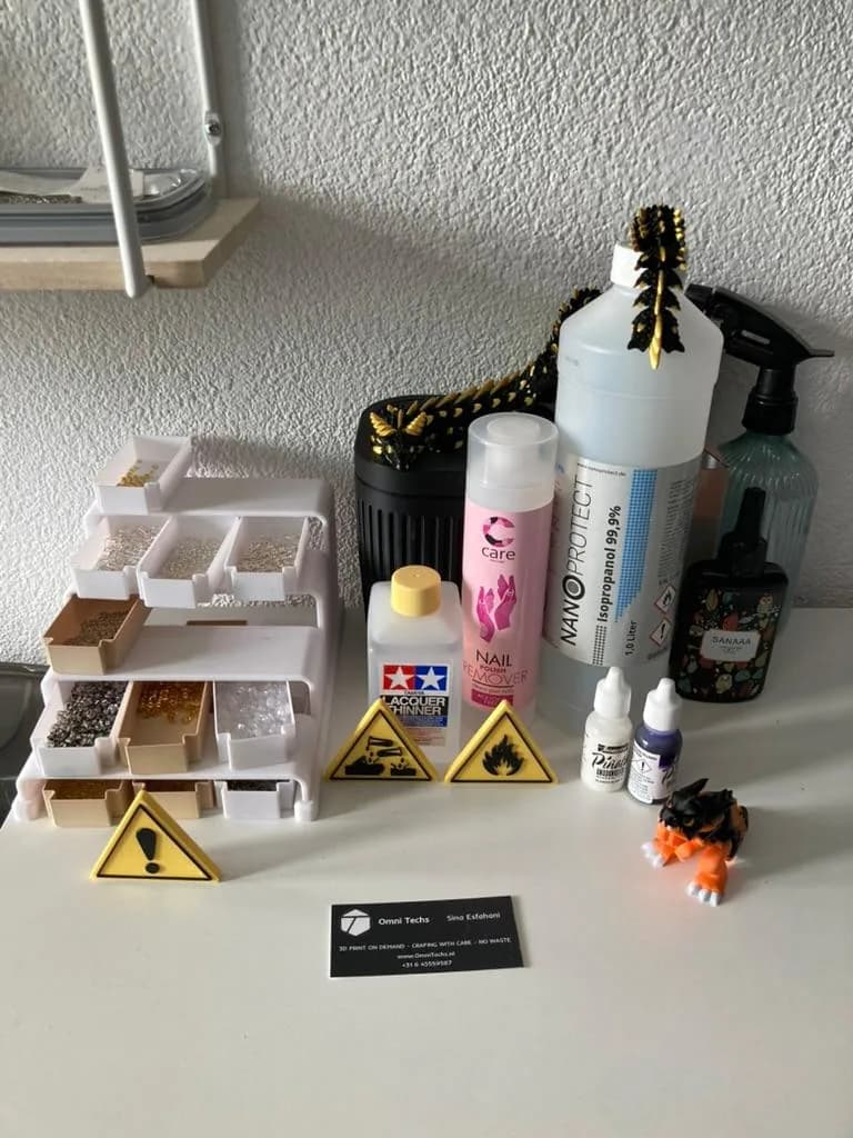 Finishing station with isopropanol, pigments, sorted hardware and hazard labels.