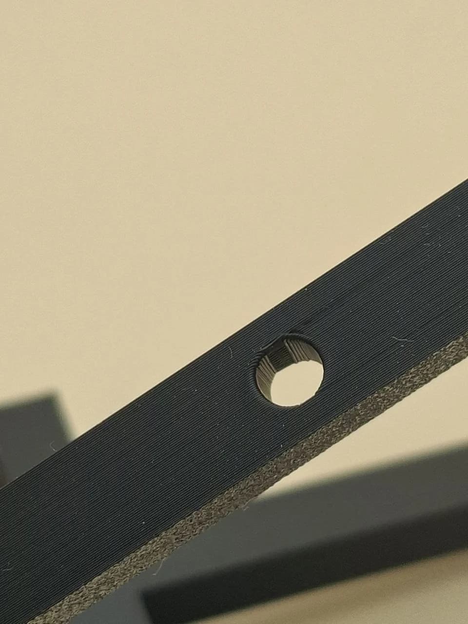 Version 2 hole at 0.12 mm layer height with remaining bridge strands.