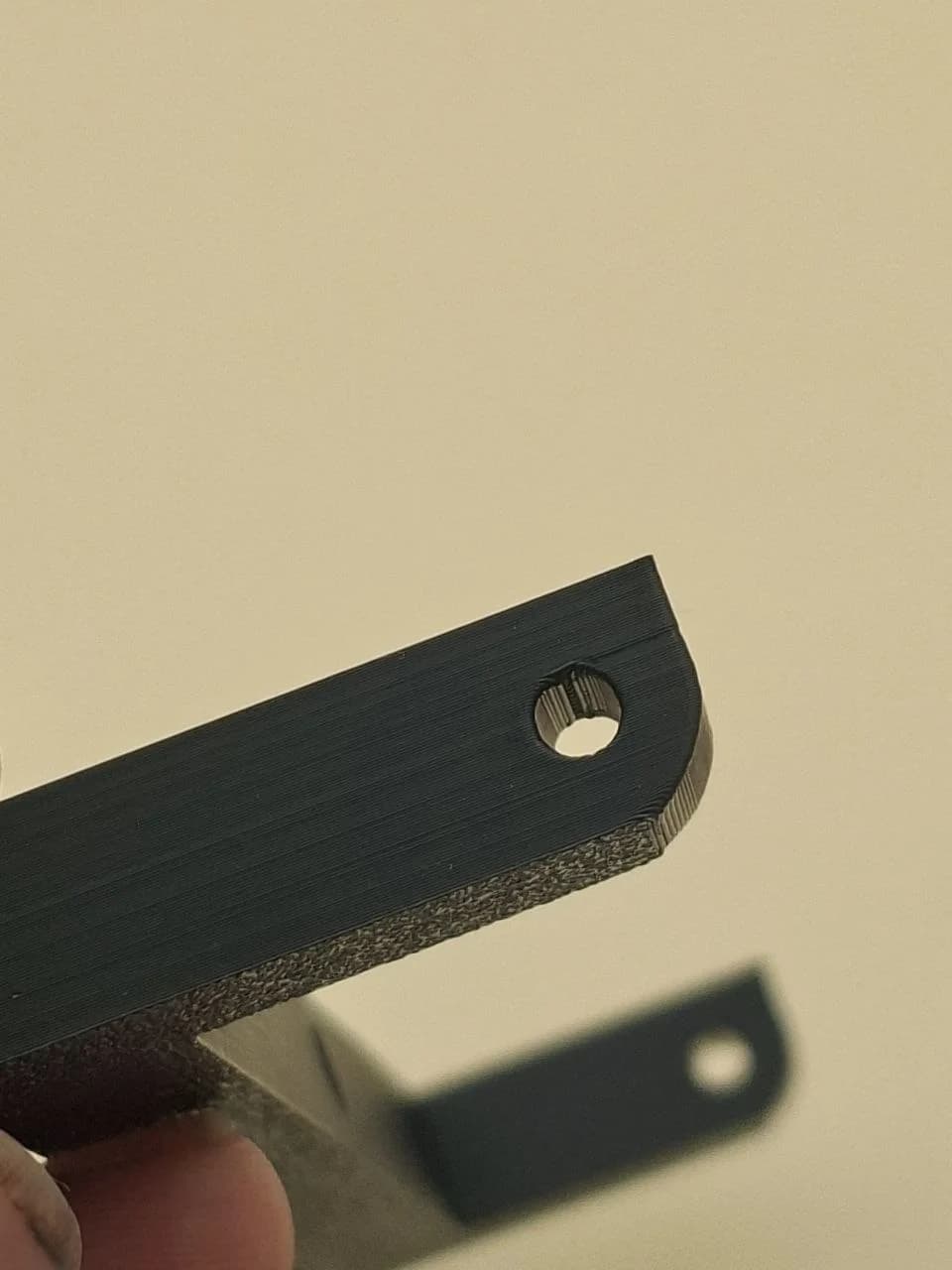 Close-up of remaining bridge and seam marks inside the version 3 hole.