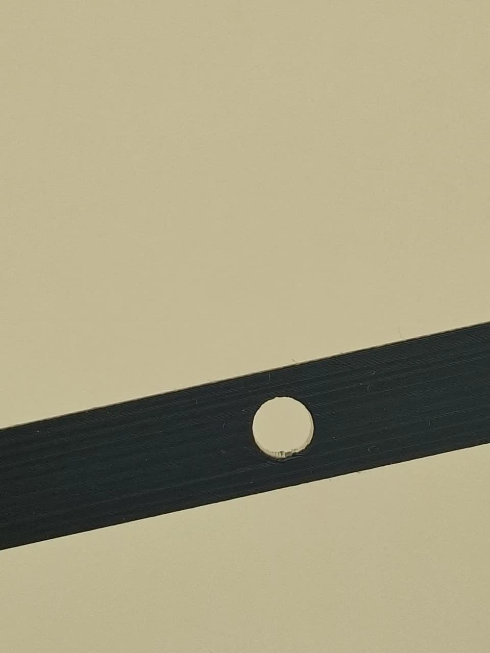 Local seam mark on the underside of the version 3 horizontal hole.